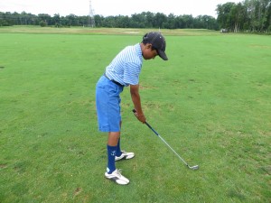 Junior golfer with perfect grip and posture